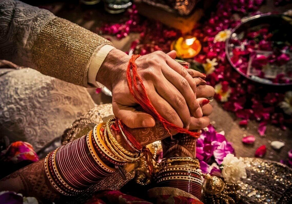The panigrahana ("accepting the hand") ritual of a Hindu wedding, where the groom accepts the bride by taking her right hand in his. This might be the first time the couple has physically touched one another. During this ritual the husband accepts his bride and vows to her and her parents that he will take care of and protect his bride for the rest of her life. Delhi 2008